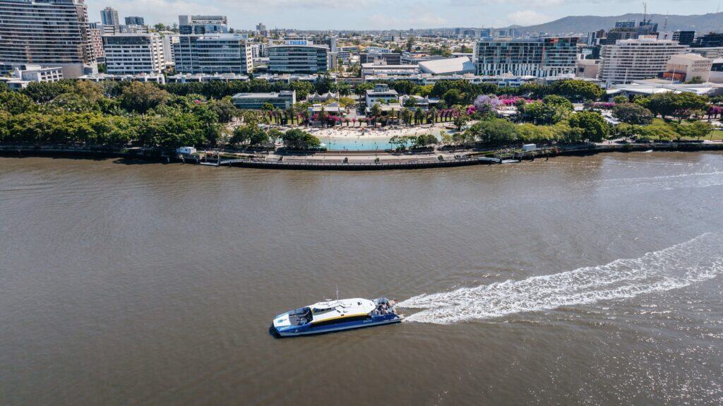Aerial view of man made lagoon and parklands with river in foreground