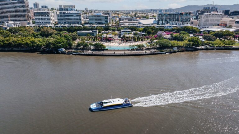 Aerial view of man made lagoon and parklands with river in foreground