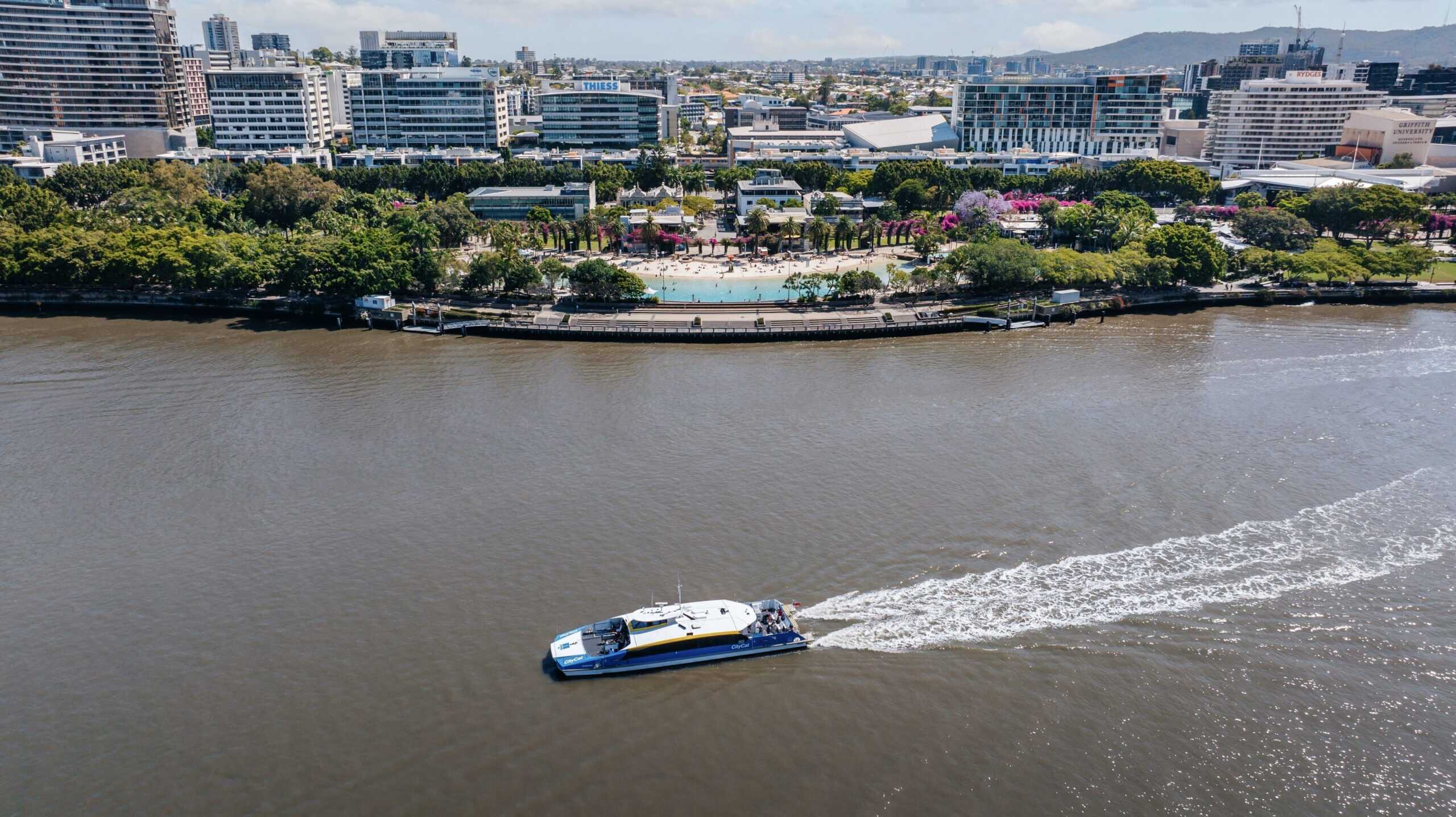 Aerial view of man made lagoon and parklands with river in foreground