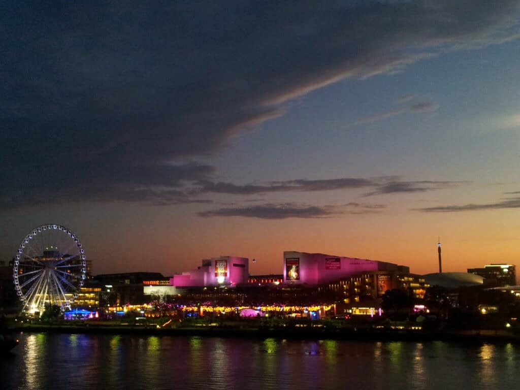 South Bank Brisbane QPAC Wheel of Brisbane illuminated at night with lights reflecting on water