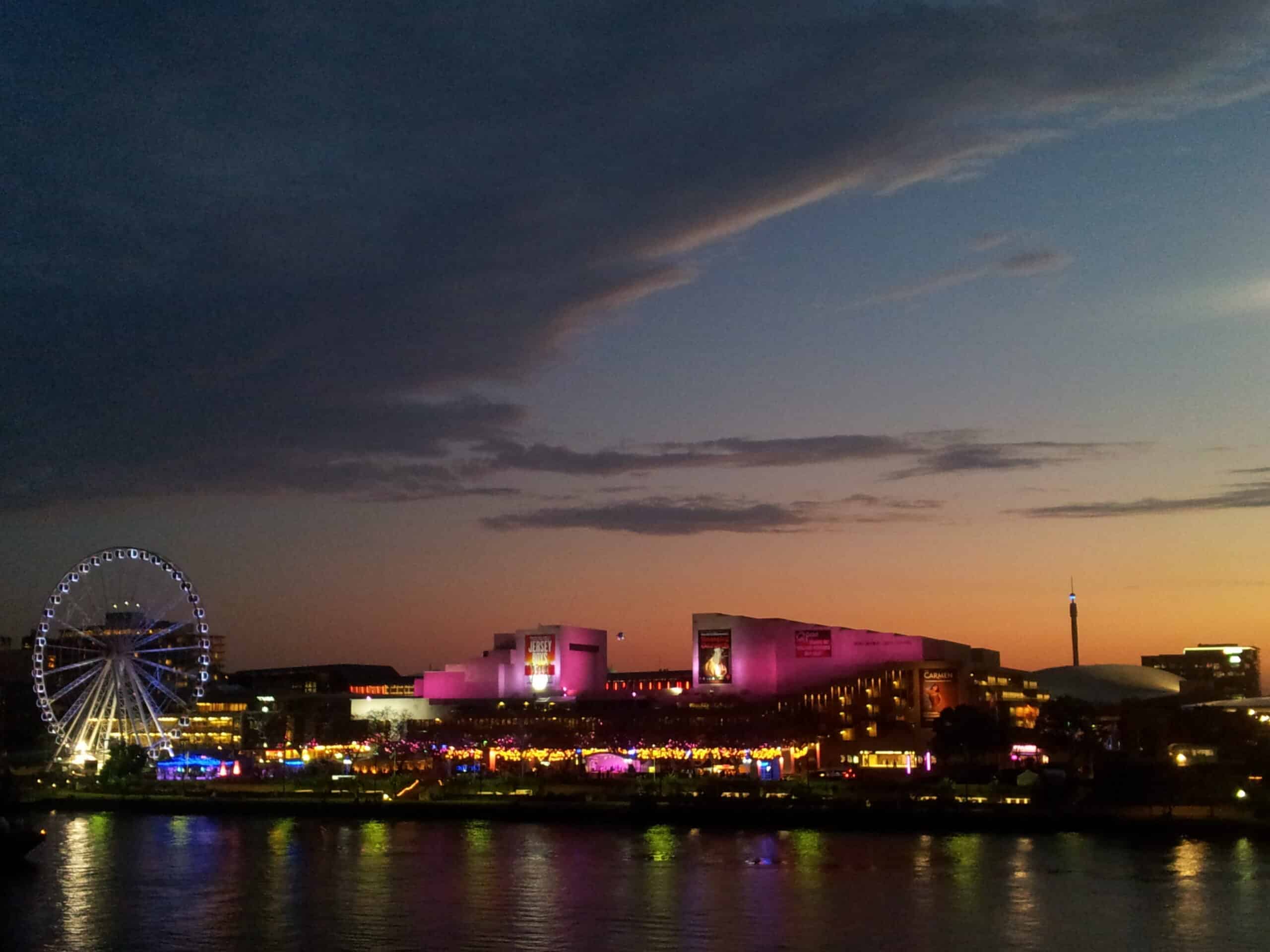 South Bank Brisbane QPAC Wheel of Brisbane illuminated at night with lights reflecting on water