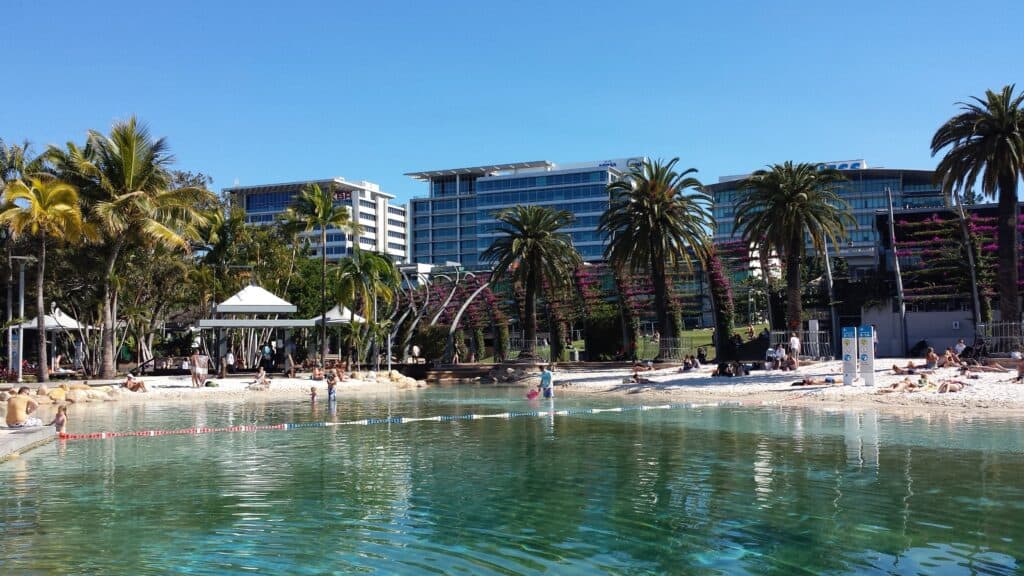 Lagoon with tropical landscaping with office buildings in background