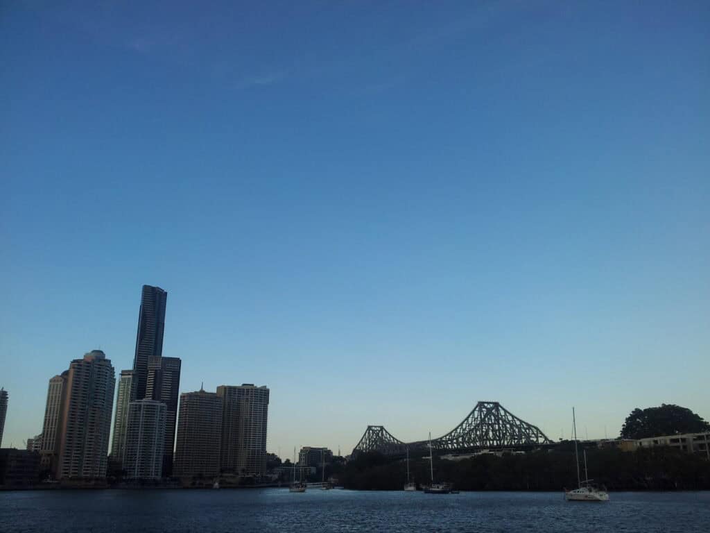 Bridge and city buildings adjacent river