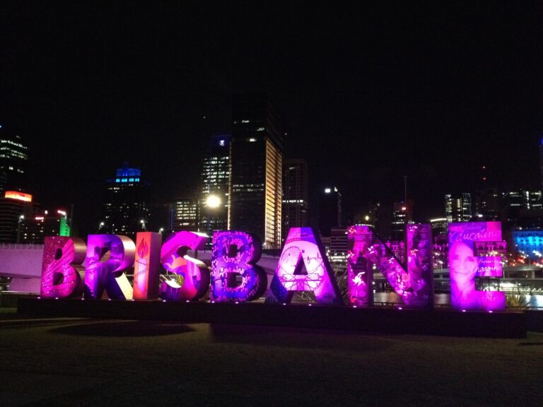 The word BRISBANE in adult size letters illuminated at night