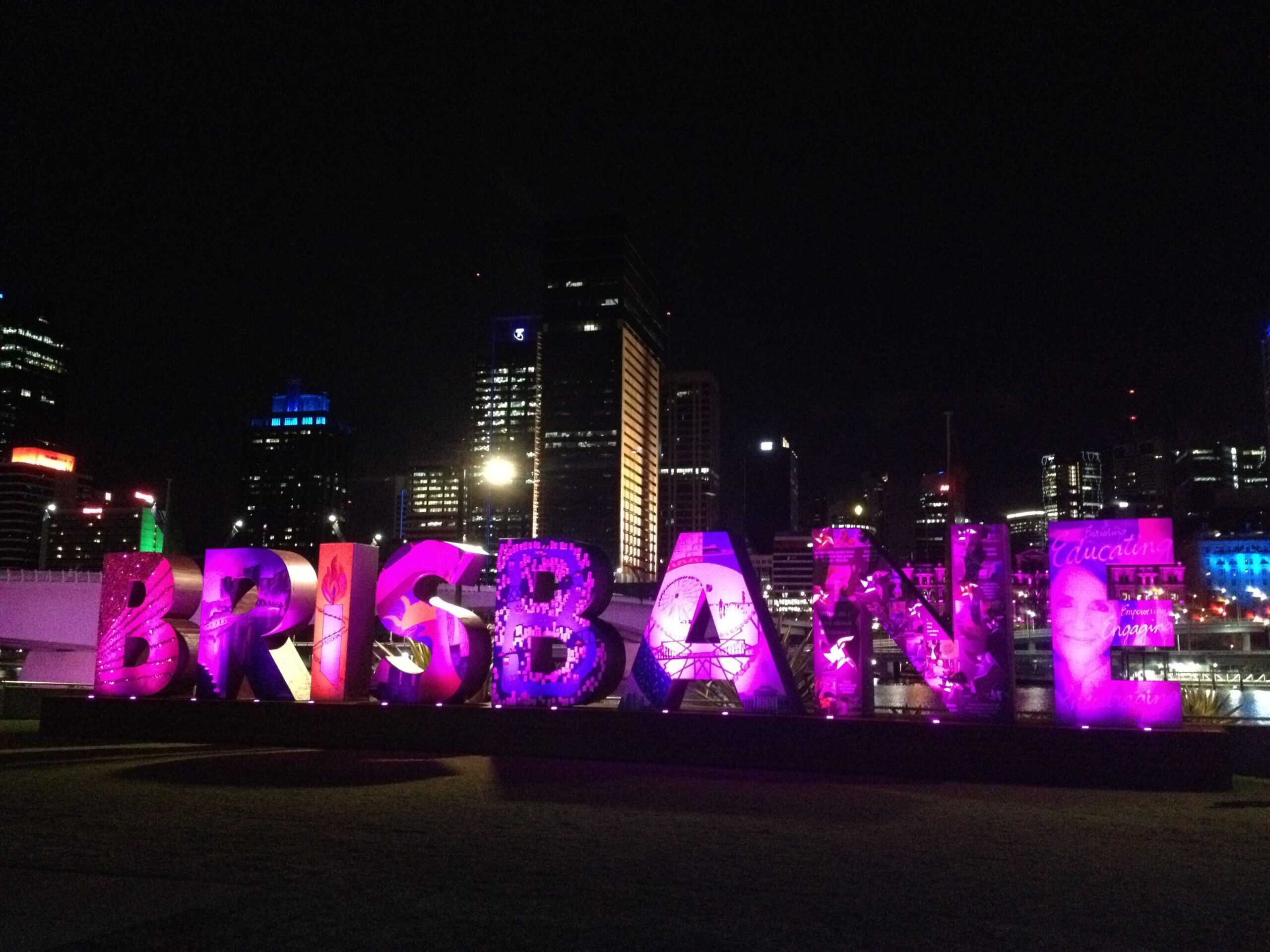 The word BRISBANE in adult size letters illuminated at night