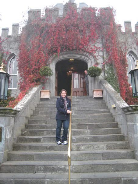 old stone manor with Sommer posing on front steps