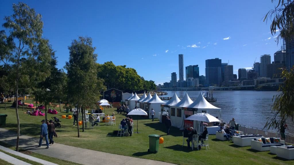 Tents and temporary seating in park by river at South Bank Brisbane