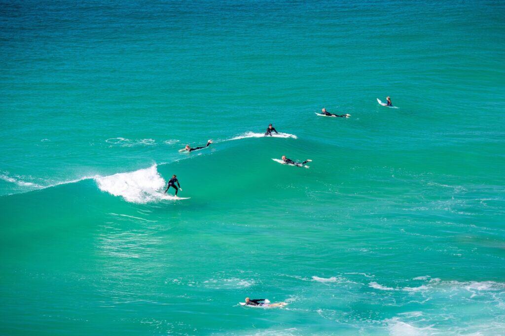 surfers on blue green waves