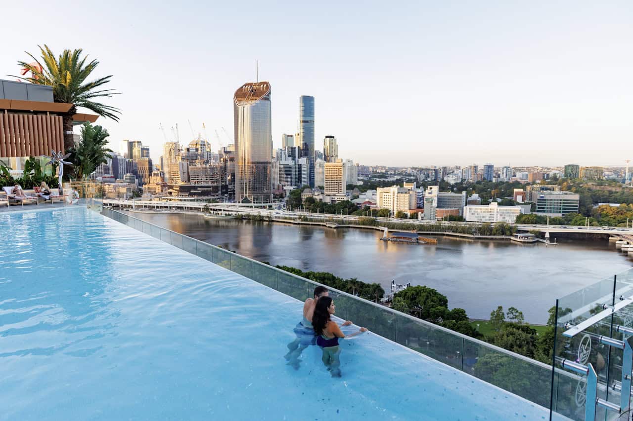 pool on hotel rooftop overlooking river and city