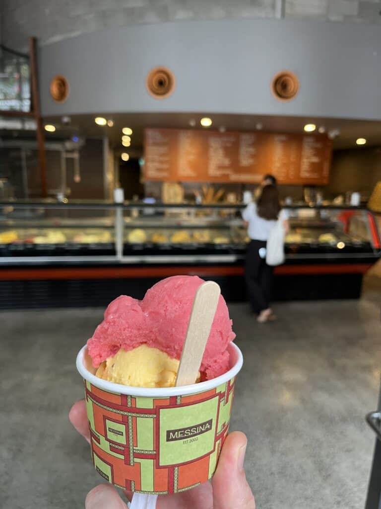 cup of orange and yellow sorbet in ice cream shop
