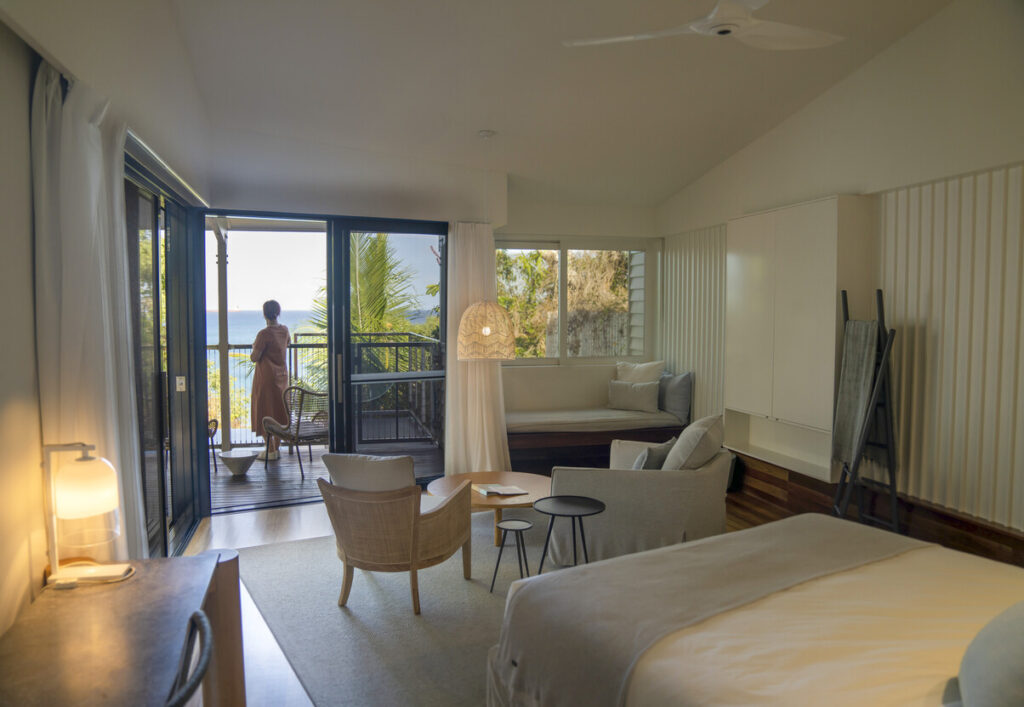 Internal view of an Oceanview Plunge Pool Villa, with a lady standing on the balcony