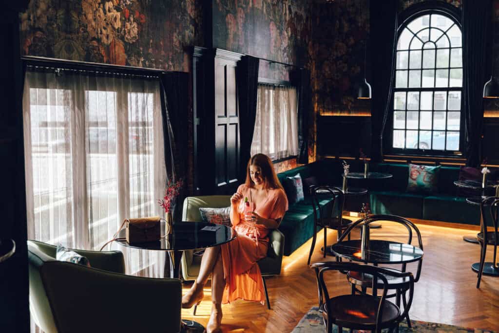 Lady enjoying a drink at the bar, in The Inchcolm by Ovolo