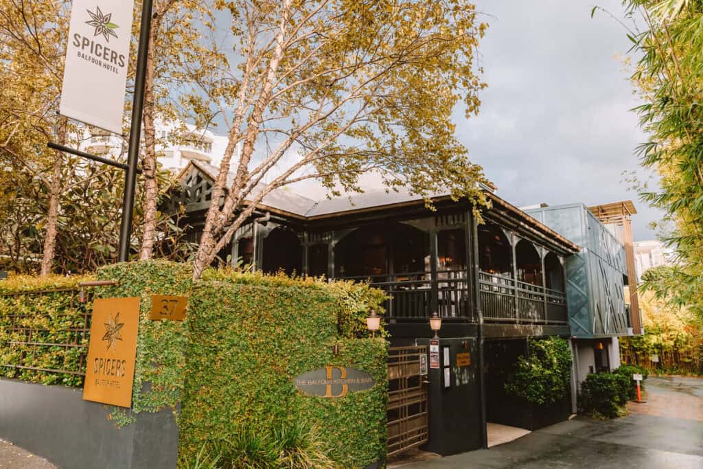 Queenslander style house with balcony and hedge