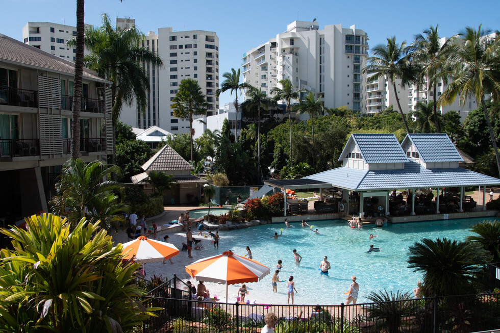 lagoon pool in hotel resort with families swimming
