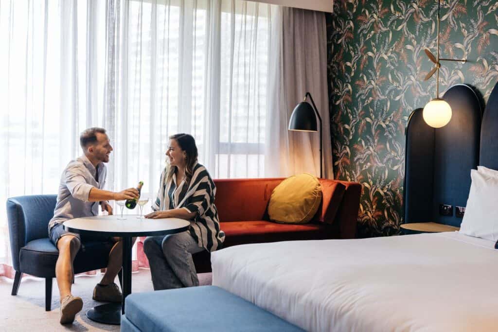 Couple enjoying a drink in hotel room