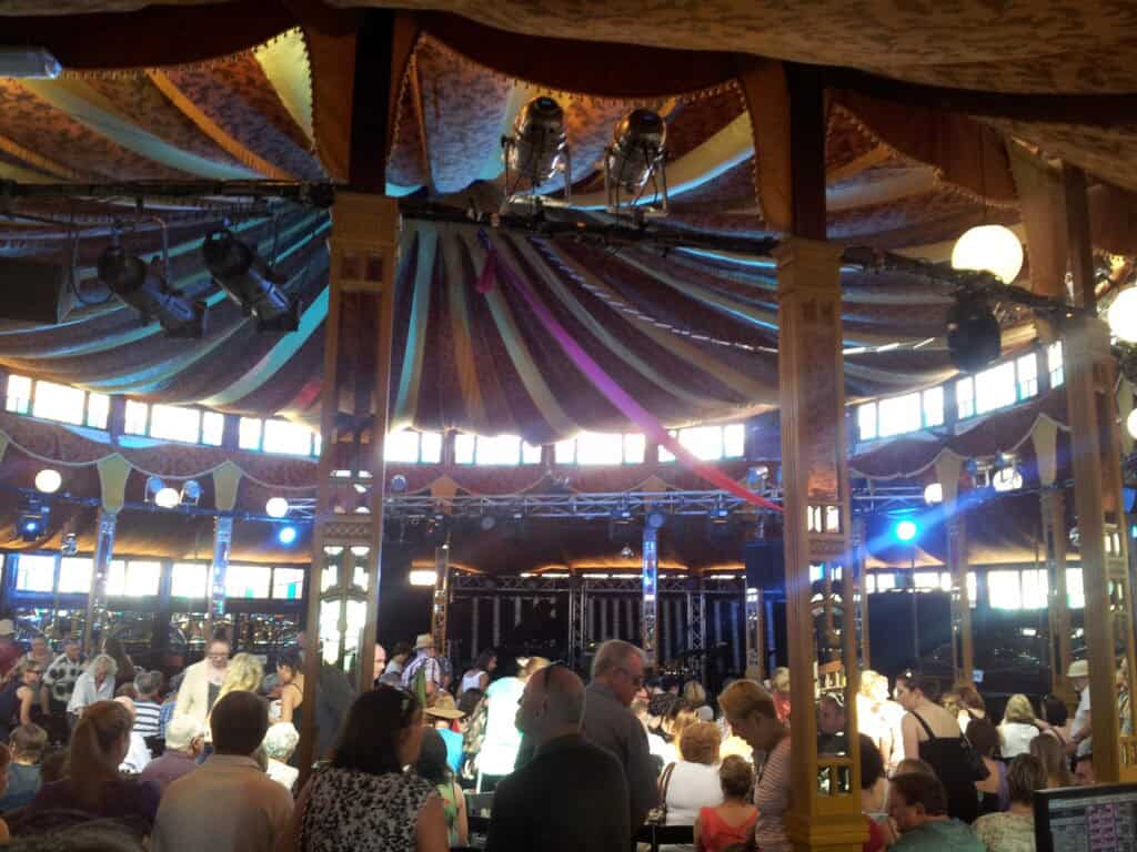 interior circus tent with crowd of people watching stage