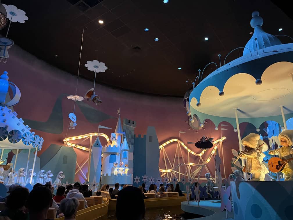 people in canal boats inside it's a small world ride in Disney